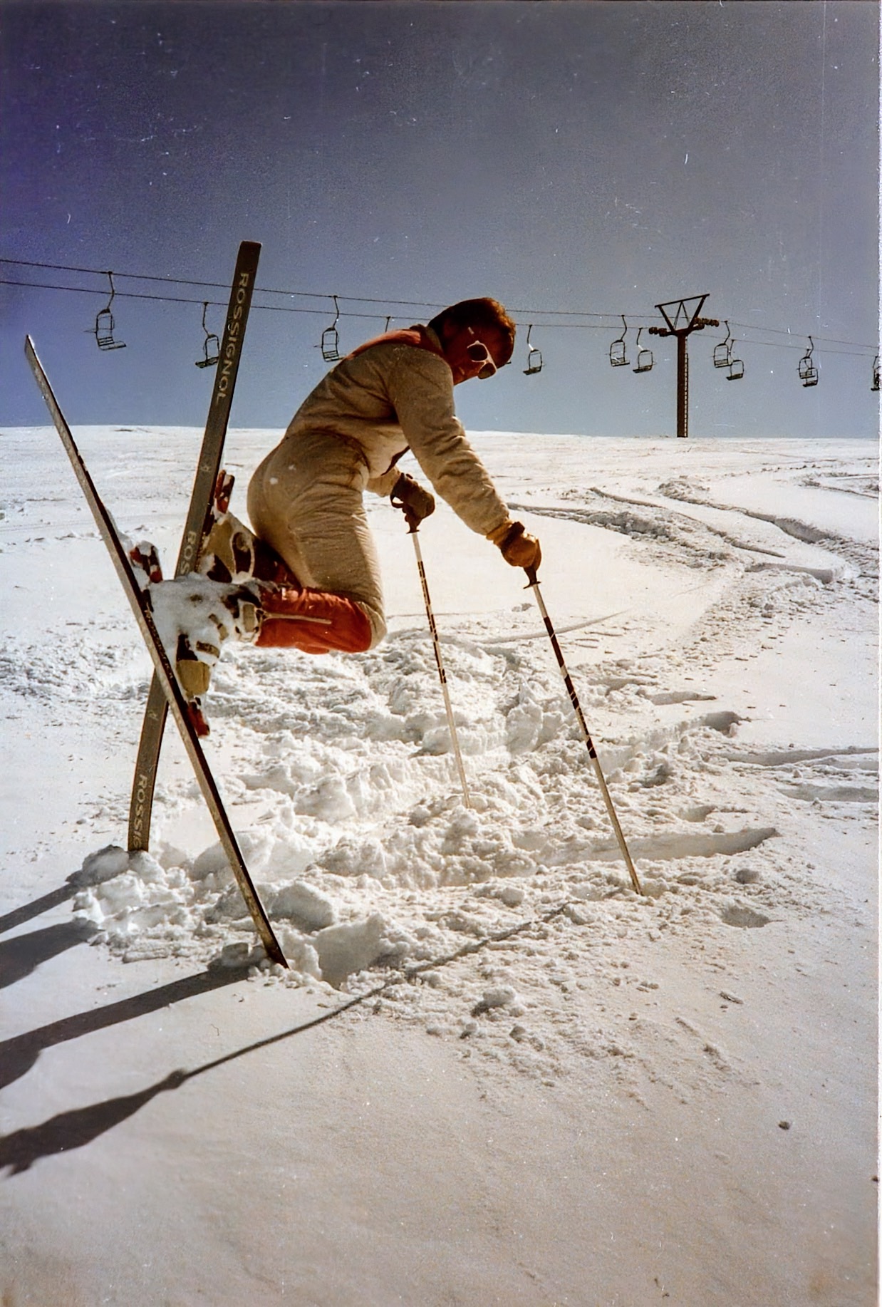 Skifahrer stürzt, die Ski stecken senkrecht im Schnee